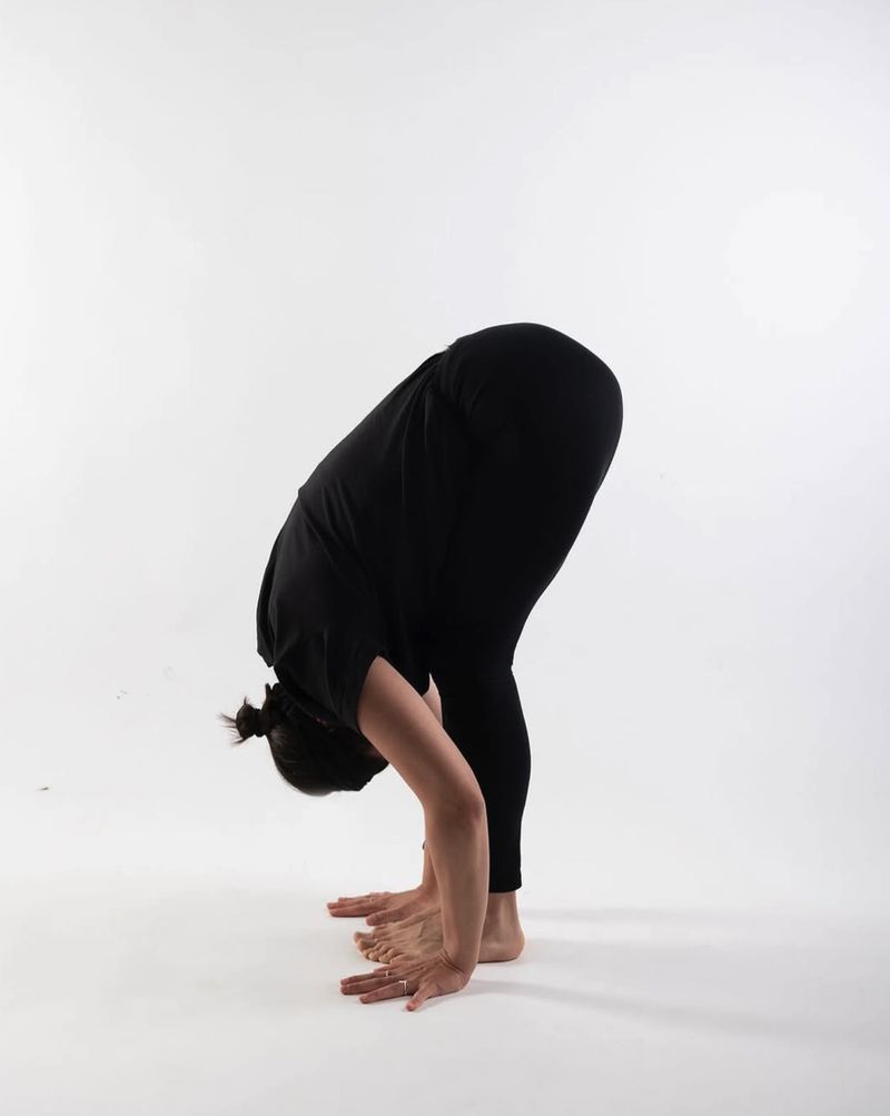 Alice folding forward from standing, hands on the floor